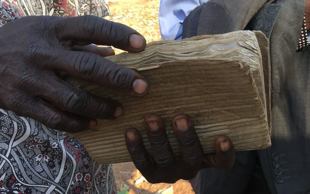 African Pastor with worn Bible